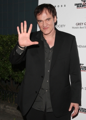 Quentin Tarantino waves on his way to The Cinema Society screening of ‘Inglourious Basterds’ at SVA Theater in New York City on August 17, 2009 