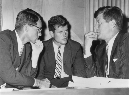 American politician brothers, US attorney-general Robert Kennedy (1925 - 1968), US senator Edward ‘Ted’ Kennedy, and US president John F. Kennedy (1917 - 1963) speak while seated behind a desk, circa 1962