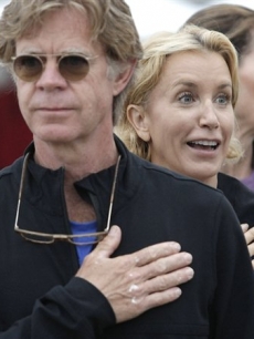 William H. Macy and wife Felicity Huffman look on during the singing of the National Anthem at the Nautica Malibu Triathlon in Malibu, Calif., on September 13, 2009