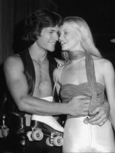 Patrick Swayze shares a laugh with his wife, dancer and actress Lisa Niemi at the premiere party for the movie ‘Skatetown USA’ at Flippers roller rink, Los Angeles, California, October 1979