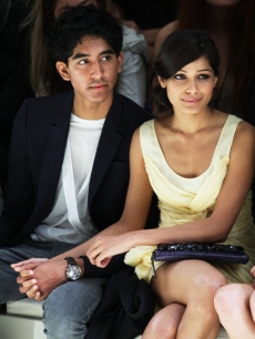 Dev Patel and Freida Pinto hold hands at the Burberry Prorsum Spring/Summer 2010 Show during London Fashion Week on September 22, 2009 in London, England