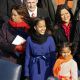 Marian Robinson (L) and granddaughters Malia and Sasha Obama stand on the stage ahead of the inauguration of Barack Obama in Washington, D.C. on January 20, 2009