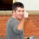 Simon Cowell shows off the thumbs up outside Fountain Studios, in Wembley, London, October 30, 2009