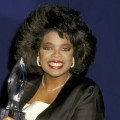 Oprah Winfrey grins as she holds a statute at the 14th Annual People’s Choice Awards, Mar. 13, 1988