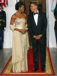 First Lady Michelle Obama and President Barack Obama pose before the White House State Dinner on November 24, 2009
