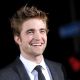Robert Pattinson smiles as he hits the red carpet of ‘The Twilight Saga: New Moon’ premiere, LA, Nov. 16, 2009