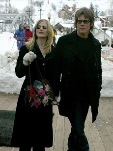 Kyra Sedgwick and Kevin Bacon walk on Main Street during the 2004 Sundance Film Festival on January 19, 2004
