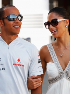 Lewis Hamilton and Nicole Scherzinger of the Pussycat Dolls walk in the paddock before the European Formula One Grand Prix at the Valencia Street Circuit on August 23, 2009, in Valencia, Spain