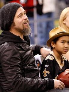 Brad Pitt, son Maddox Jolie-Pitt and actress Patricia Clarkson at a New Orleans Saints game at Louisana Superdome on January 16, 2010 in New Orleans, Louisiana