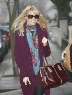 Claudia Schiffer, who is expecting her third child, smiles as she steps out in London, Jan. 18, 2010