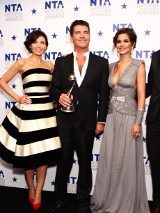 Dannii Minogue, Simon Cowell and Cheryl Cole pose backstage after winning most popular talent show for ‘X Factor’ at the National Television Awards at the O2 Arena in London, England on January 20, 2010