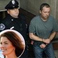 Mark Kerrigan, the brother of figure skater Nancy Kerrigan, is led in handcuffs out of Woburn, Mass. District Court after his arraignment on January 25, 2010