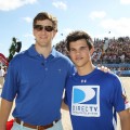 NFL star Eli Manning and Taylor Lautner share a moment at the Fourth Annual DIRECTV Celebrity Beach Bowl at DIRECTV Celebrity Beach Bowl Stadium South Beach on in Miami Beach, Fla., on February 6, 2010