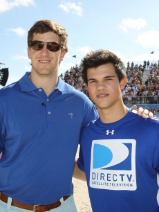 NFL star Eli Manning and Taylor Lautner share a moment at the Fourth Annual DIRECTV Celebrity Beach Bowl at DIRECTV Celebrity Beach Bowl Stadium South Beach on in Miami Beach, Fla., on February 6, 2010
