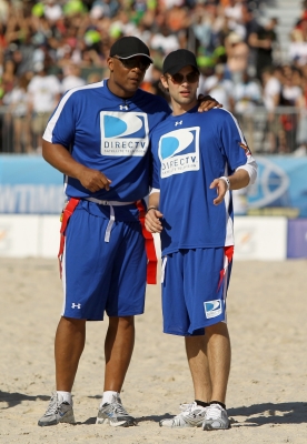 NFL legend Warren Moon talks with Chace Crawford during the DIRECTV Celebrity Beach Bowl on February 6, 2010 in Miami Beach, Florida