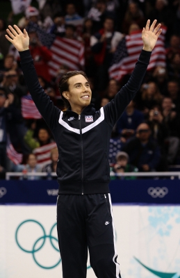 Apolo Anton Ohno waves to fans on the medal stand for his bronze in the 1000m at the 2010 Winter Olympics in Vancouver, Canada, on February 20, 2010