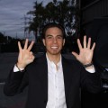 Apolo Anton Ohno raises eight fingers to represent his eight Olympic medals outside the Access set in March 2010