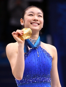 Kim Yu-Na of South Korea celebrates winning the gold medal in the Ladies Free Skating during the medal ceremony on day 14 of the 2010 Vancouver Winter Olympics at Pacific Coliseum on February 25, 2010