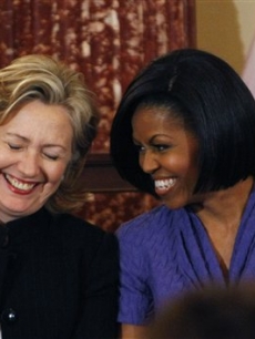 First Lady Michelle Obama and Secretary of State Hillary Clinton share a laugh as they present the 2010 International Women of Courage Awards at the State Department in Washington, D.C. on March 10, 2010