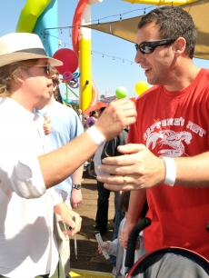David Spade and Adam Sandler share a moment at the Make-A-Wish Foundation’s Day of Fun hosted by Kevin & Steffiana James at Santa Monica Pier in Santa Monica, Calif., on March 14, 2010