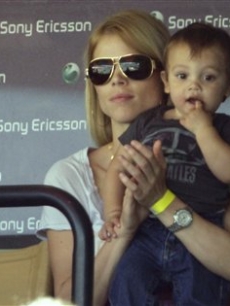 Elin Nordegren, the wife of Tiger Woods, sits with her son Charlie during a semifinal match between Rafael Nadal and Andy Roddick at the Sony Ericsson Open tennis tournament in Key Biscayne, Fla. on April 2, 2010