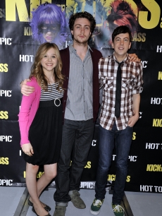 Chloe Grace Moretz, Christopher Mintz-Plasse and Aaron Johnson pose for a picture at the ‘Kick Ass’ cast meet and greet fan event held at Hot Topic on April 12, 2010 in Hollywood
