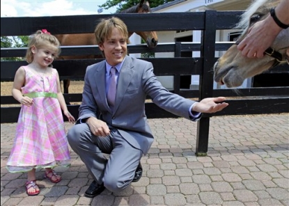 Larry Birkhead and daughter Dannielynn feed a pony at the Kentucky Derby Museum in Louisville, Ky. on April 28, 2010
