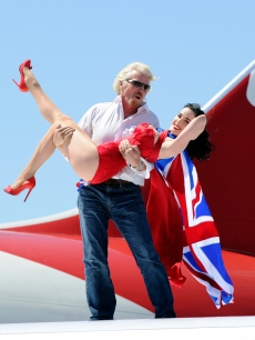 President of Virgin Group Sir Richard Branson and burlesque artist Dita Von Teese appear on the wing of a Virgin Atlantic Airways 747-400 aircraft at McCarran International Airport, Las Vegas, June 15, 2010