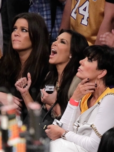 Khloe and Kim Kardashian cheer on the LA Lakers alongside their mom, Kris Jenner, at Game 7 of the NBA Finals between the Boston Celtics and LA Lakers at the Staples Center in Los Angeles on June 17, 2010
