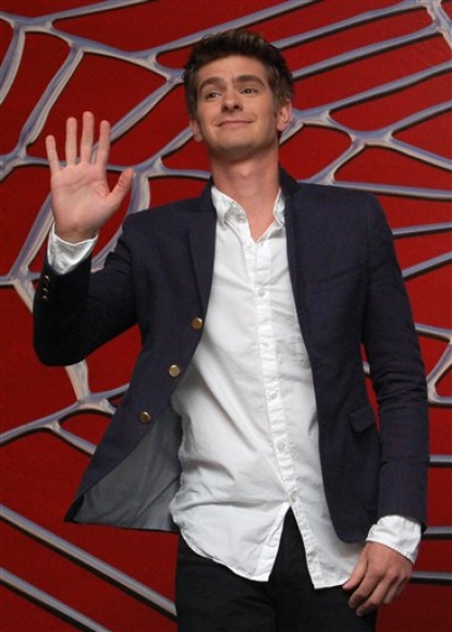 Andrew Garfield waves and flashes a smile at photographers as he is announced as the new “Spider-Man” during a media event in Cancun, Mexico, 1 July 2010