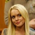 Lindsay Lohan smiles at the Beverly Hills Courthouse where she later surrendered to begin serving her 90-day jail sentence, on July 20, 2010