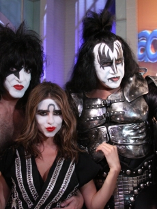Access’ Maria Menounos poses next to Gene Simmons and Paul Stanley as an honorary member of KISS in Burbank, Calif., on July 19, 2010