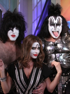 Access’ Maria Menounos poses next to Gene Simmons and Paul Stanley as an honorary member of KISS in Burbank, Calif., on July 19, 2010