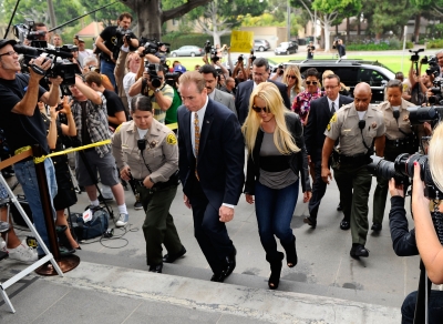Photographers surround Lindsay Lohan as she arrived at the Beverly Hills Courthouse where she surrendered to serve her 90-day jail sentence, on July 20, 2010