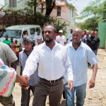 Wyclef Jean greets his neighbors before heading off for a meeting with Haitian President Rene Preval in Port-au-Prince, Haiti, on August 19, 2010