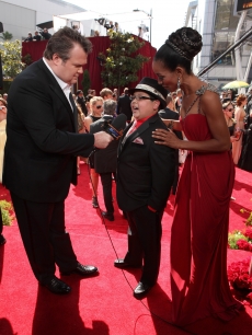 “Modern Family’s” Eric Stonestreet interviews Rico Rodriguez on the Emmys red carpet as Access Hollywood’s Shaun Robinson looks on, LA, Aug. 29, 2010