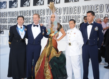 Lady Gaga arrives at the 2010 MTV Video Music Awards at Nokia Theatre L.A. Live with former members of the military in Los Angeles on September 12, 2010 