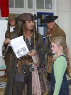 Johnny Depp holds a letter from 5-year-old Bea Delap inviting him to attend her school assembly in London on October 7, 2010
