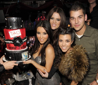 Kim, Khloe, Kourtney and Rob Kardashian pose with a birthday cake for Kim’s 30th birthday celebration at TAO in Las Vegas on October 15, 2010