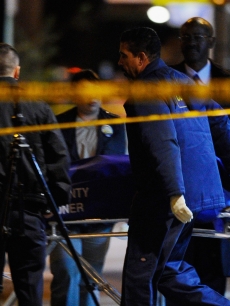 Los Angeles County Coroner removes a body from the scene of a fatal shooting at the Harvey Apartments in Los Angeles, Calif. on December 1, 2010  According to reports, a suspect thought to be connected with the murder of Ronni Chasen, fatally shot himself in the Hollywood hotel