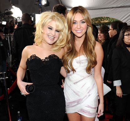 Kelly Osbourne and singer Miley Cyrus arrive at the 2010 American Music Awards held at Nokia Theatre L.A. Live in Los Angeles on November 21, 2010