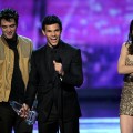 Robert Pattinson, Taylor Lautner, and Kristen Stewart accept the Favorite Movie award onstage during the 2011 People’s Choice Awards at Nokia Theatre L.A. Live in Los Angeles on January 5, 2011