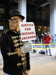 sSean Kang, a Michael Jackson fan from New York, stands outside the preliminary hearing for Dr. Conrad Murray in Los Angeles on January 4, 2011