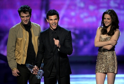 Robert Pattinson, Taylor Lautner, and Kristen Stewart accept the Favorite Movie award onstage during the 2011 People’s Choice Awards at Nokia Theatre L.A. Live in Los Angeles on January 5, 2011