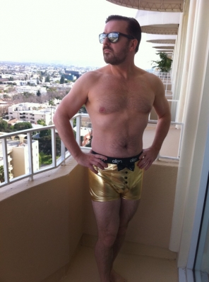 Ricky Gervais on the balcony of his hotel rocking a pair of golden “Ellen” underwear on January 17, 2011