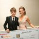Justin Bieber presents a check from CVS Pharmacy to Maria Menounos for The Lollipop Theater Network and Best Buddies charities as part of Access’ “Stuff You Must” lounge