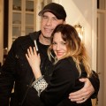 John Travolta and Drew Barrymore hug at an event at producer David Hoberman’s home in Brentwood, Calif., on February 10, 2011
