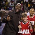 Justin Bieber and Magic Johnson celebrate at the 2011 BBVA NBA All-Star Celebrity Game at the Los Angeles Convention Center in LA on February 18, 2011 