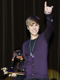 Justin Bieber holds the NRJ music award as he attends the “Justin Bieber: Never Say Never” Paris premiere on February 17, 2011
