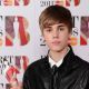 Justin Bieber poses with his award for International Breakthrough Act at the BRIT Awards 2011 at the O2 Arena in London on February 15, 2011